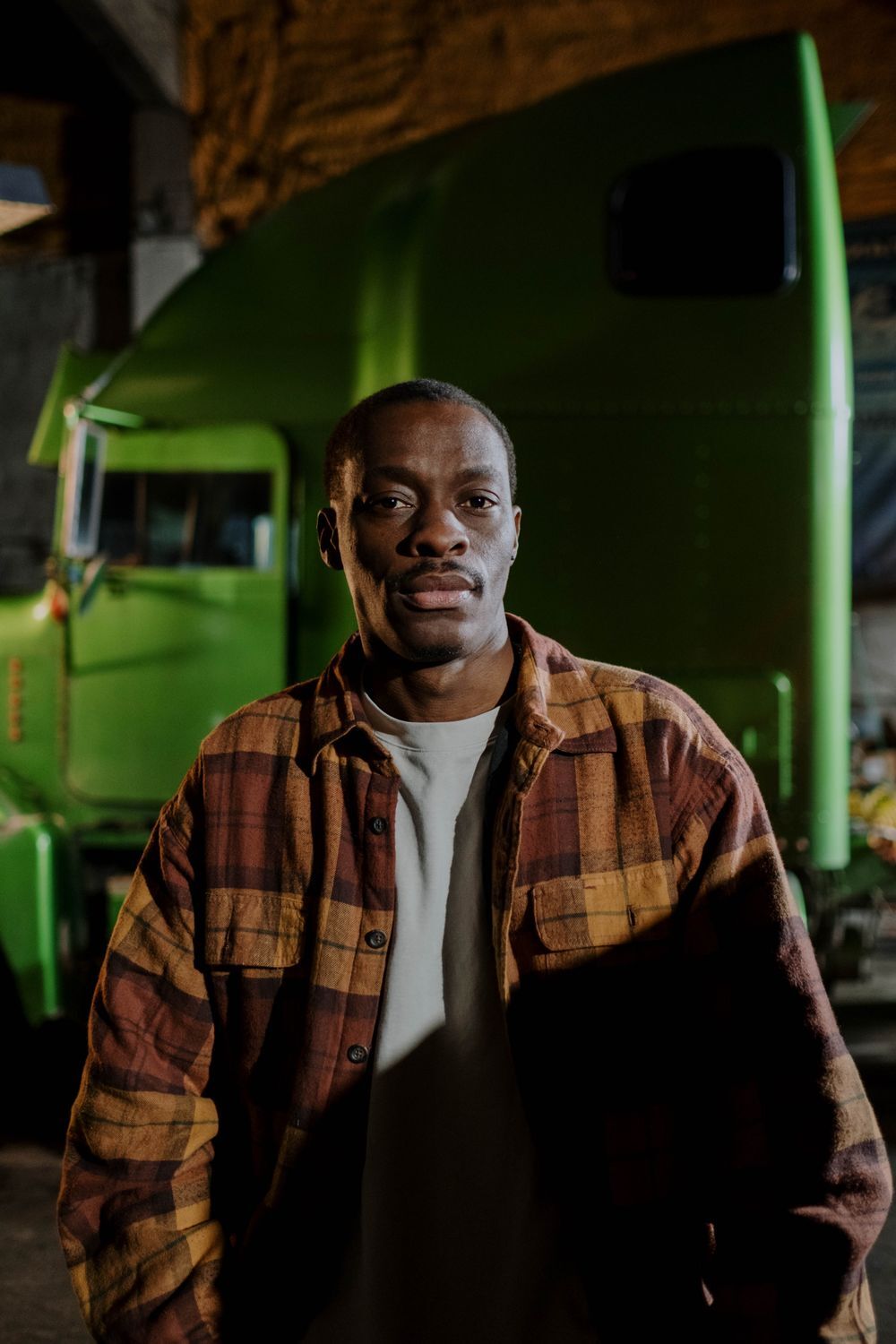 Professional driver standing in front of a haulage truck