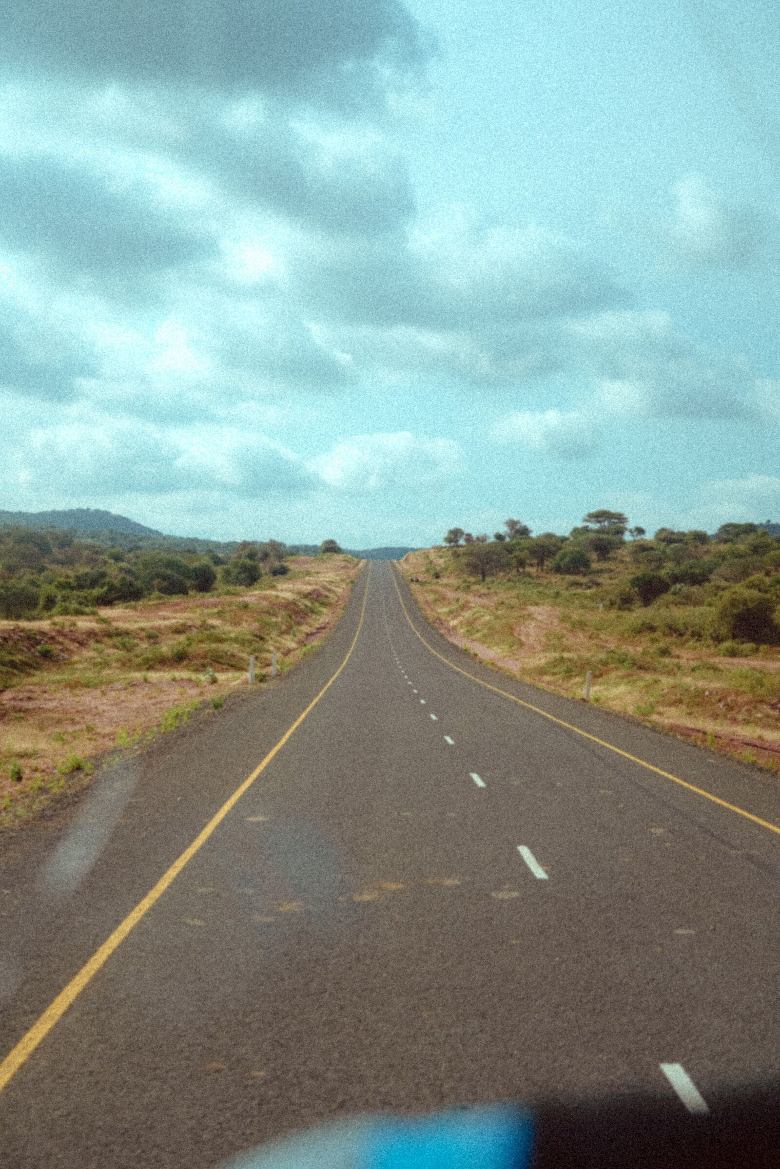 Open tarred highway cutting through Southern African bush